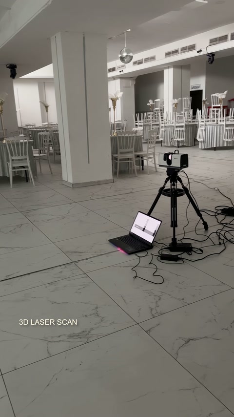 Survey equipment capturing structural details inside the wedding venue