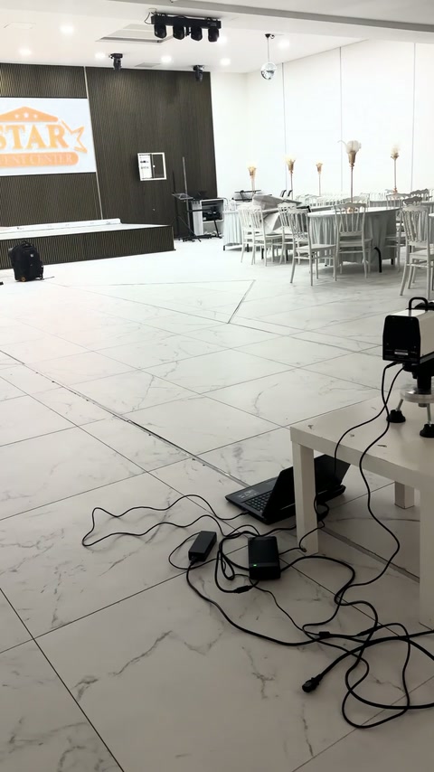 Measurement equipment operating across the open wedding hall floor