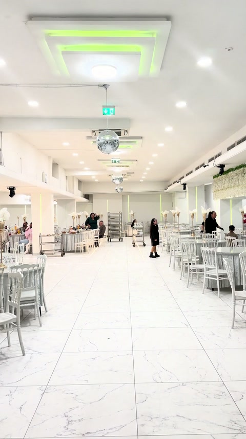 Existing banquet area showing ceiling lights and undecorated interior surfaces