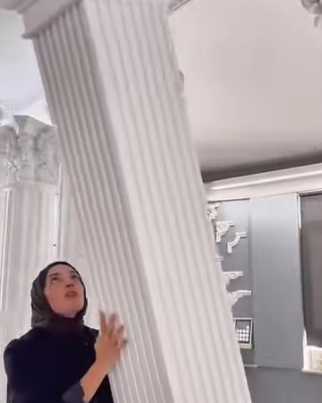 The channel details of a tall fluted column are visible from a low angle