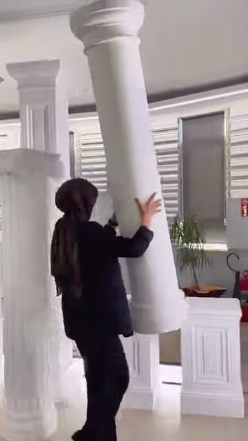 Una colonna cilindrica diritta viene presentata con capitello a strati e base quadrata sottostante.