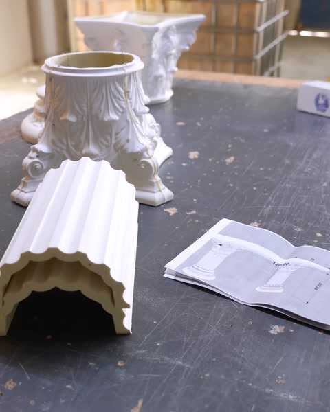 Polyurethane column base and capital pieces resting on factory floor