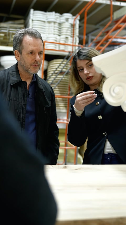 Design team reviews a decorative moulding sample in the factory
