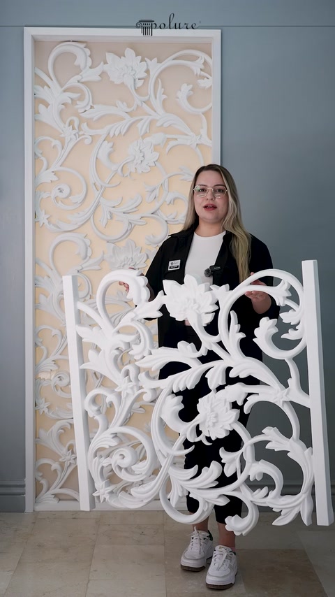 Intricate white ornamental appliques create a detailed decorative wall display