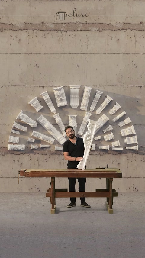 Worker applies finishing material around an interior arched opening