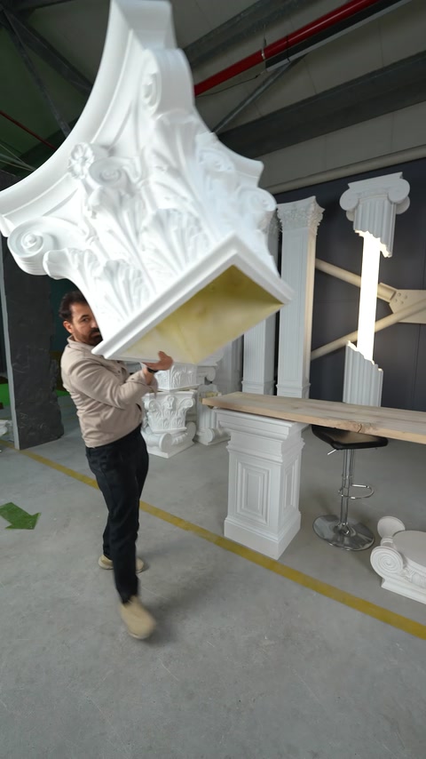 Worker handles an oversized ornate polyurethane corbel component