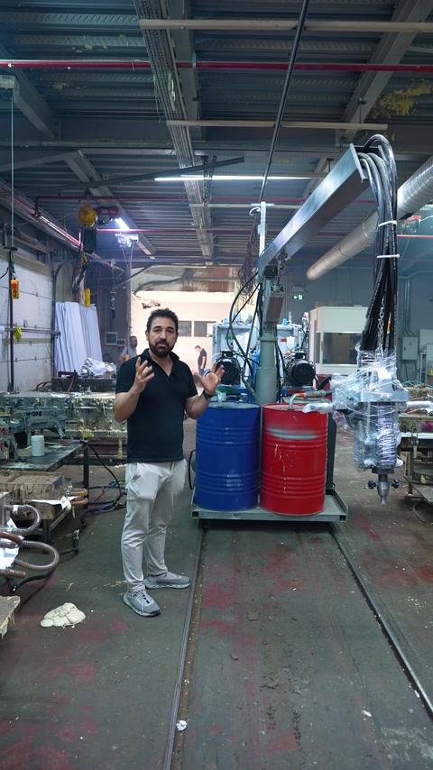 Specialist explains polyurethane manufacturing equipment on the factory floor