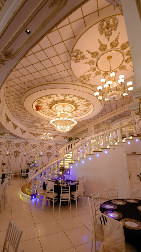 Grand interior features ornate ceiling panels, mouldings, and columns