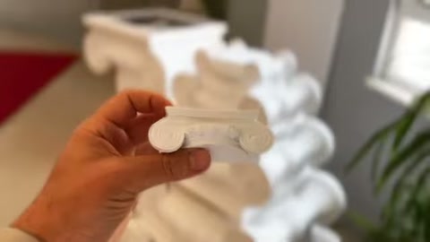 The rounded end and stepped details of a white profile sample are highlighted.