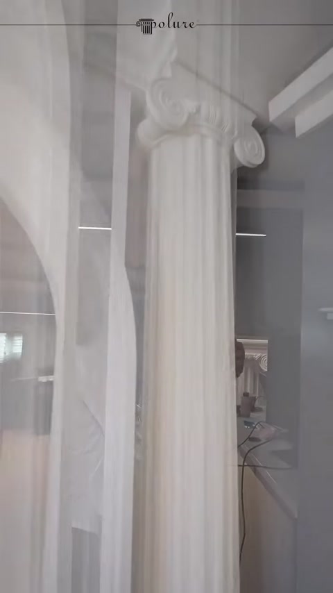 A close-up view of a voluted column capital and fluted shaft