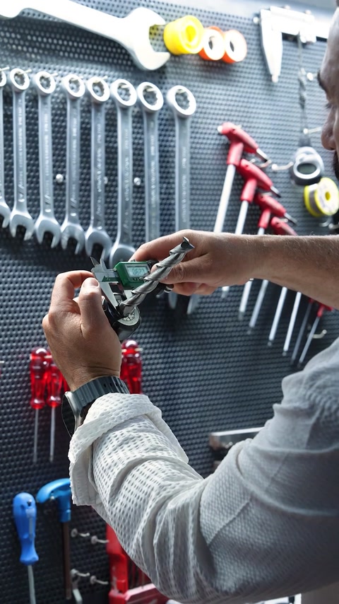 Close view of hand tools arranged on a workshop tool wall