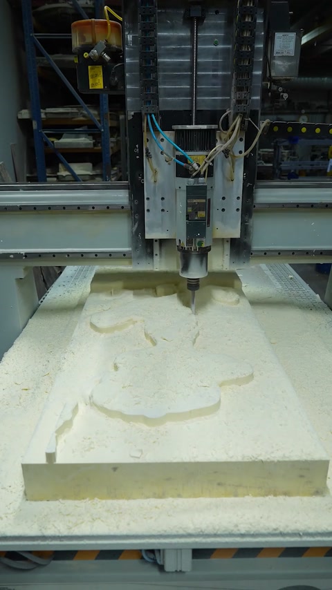 CNC machine begins carving a detailed relief into the panel