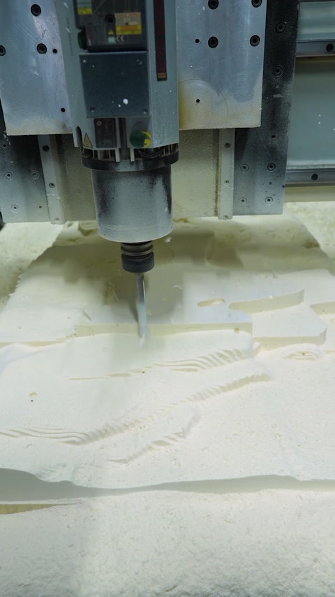 Freshly machined relief surface reveals layered decorative contours
