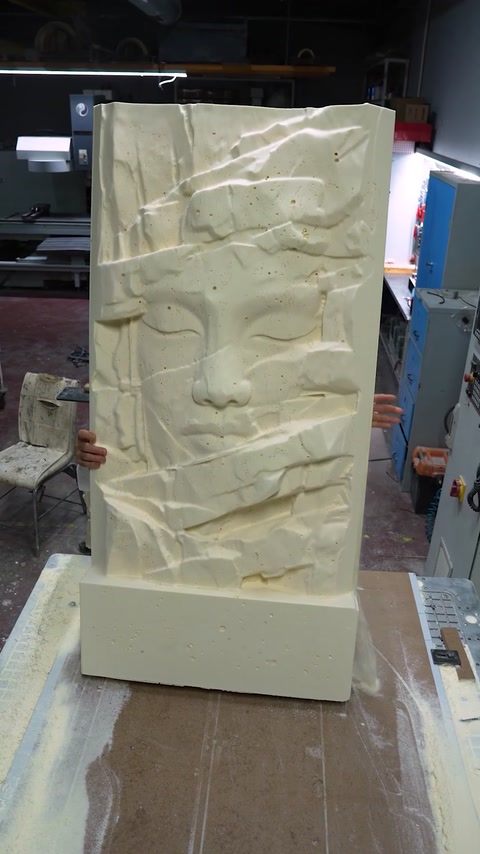 Large decorative relief panel stands upright after detailed machining