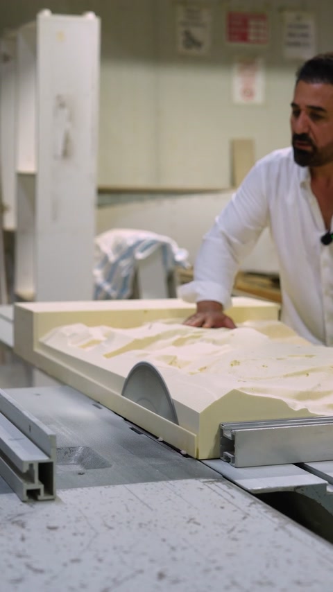 Worker examines the completed relief panel in the production area