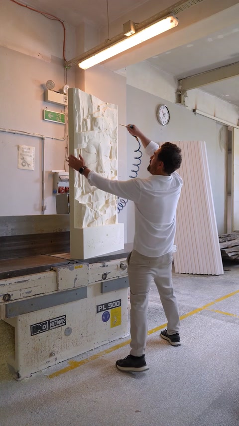Decorative panel is positioned against a wall inside the workshop