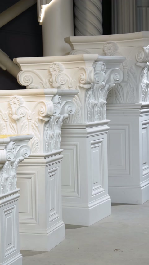 White acanthus capitals sit on square paneled bases for comparison