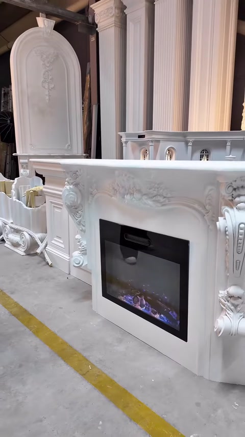 A decorative fireplace model with columns is shown in its entirety in a showroom setting