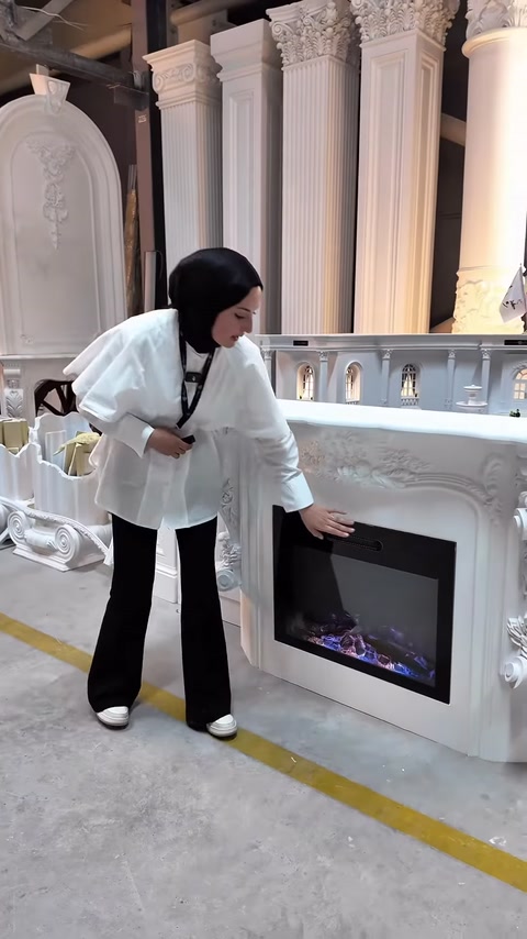 The presenter demonstrates the touchscreen section of the electric fireplace