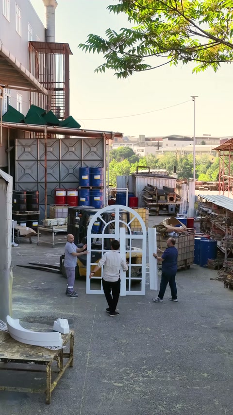 Crew positioning frame pieces on both sides of standing arched window