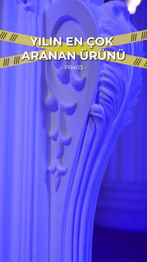 The raised side ornaments of the curved fireplace surround are displayed up close.