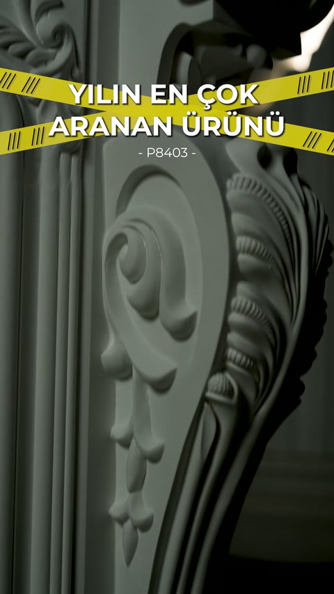 Spiral-motif side ornamentation on completed fireplace frame captured in close view.