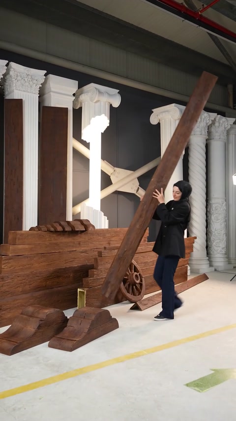 Woman lifts diagonal polyurethane beam demonstrating its lightweight design