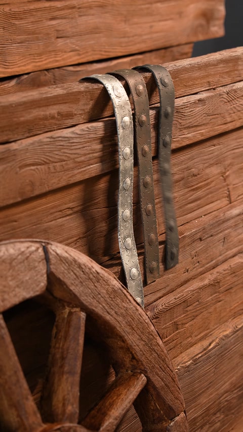 Detailed view of metal strap wrapped around wood-look wheel rim