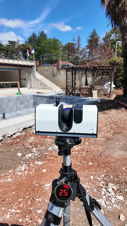 A tripod-mounted 3D scanner records conditions at an outdoor project site.