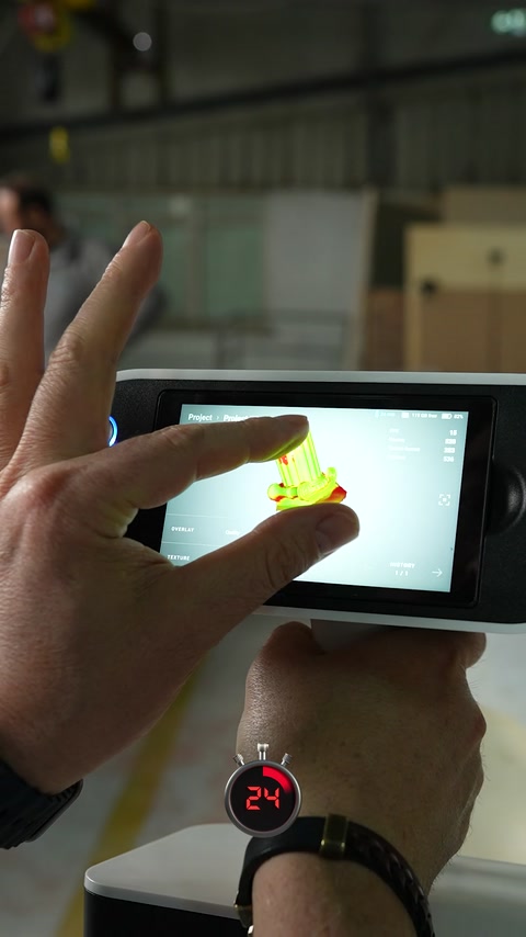 A handheld device displays a digital scan of an architectural detail.