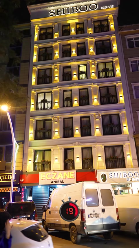 Illuminated facade moldings emphasize windows and cornices on a hotel exterior.