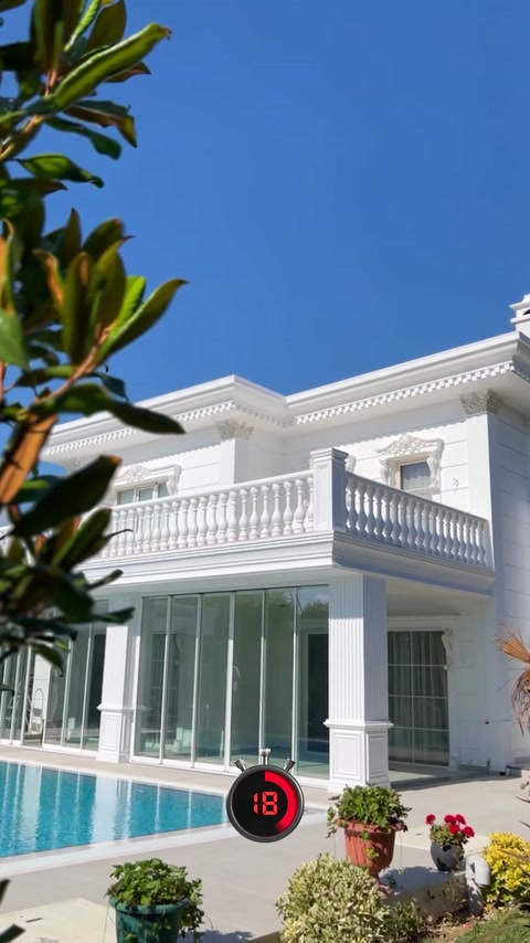 White villa exterior features cornices, columns, and decorative balustrades.
