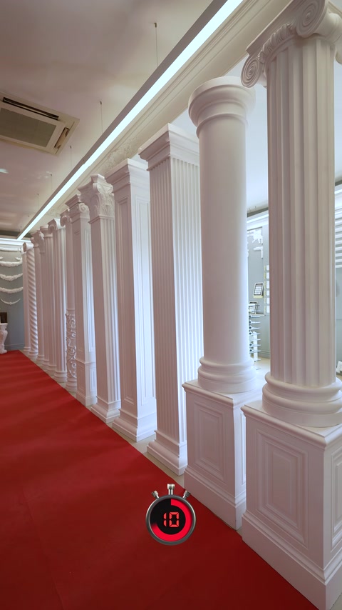 Interior corridor combines fluted columns, pilasters, cornices, and wall panels.