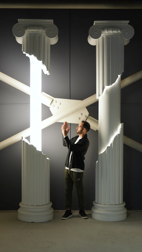 Oversized fluted columns with Ionic capitals stand inside the showroom.