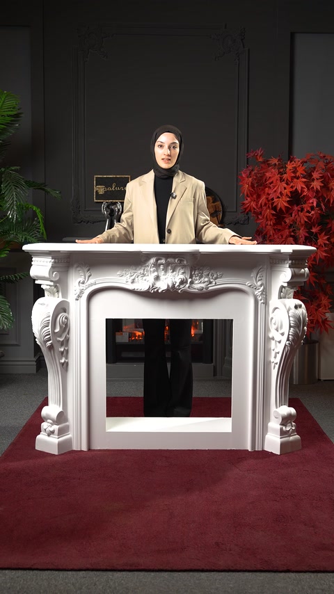 Ornate decorative fireplace surround is presented in a showroom setting.