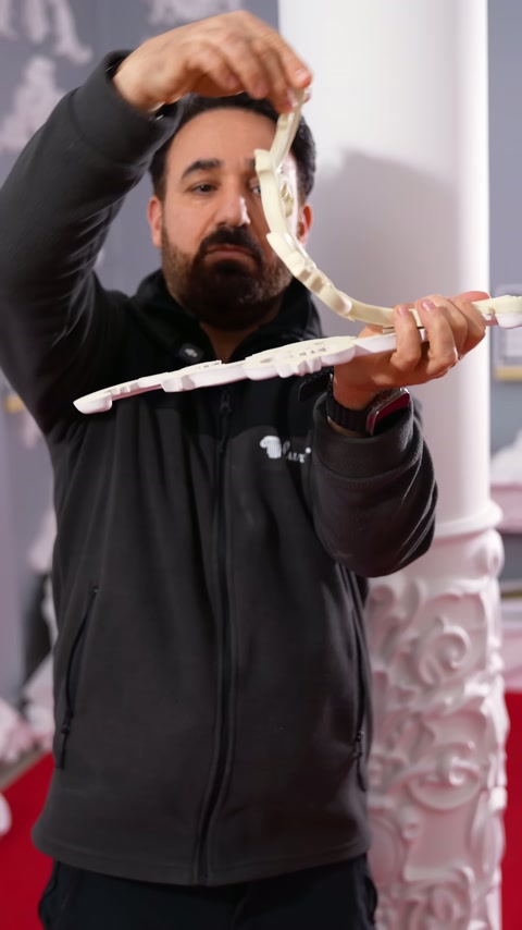 A long appliqué arm curves upward while the center section is held horizontally.