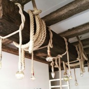 Rustic Polyurethane Beams with Rope Lighting and Classic Interior Touches Polyurethane Rustic Beams and Rope IlluminationIntegrating polyurethane beams with rope-bound suspended bulbs brings a strong rust