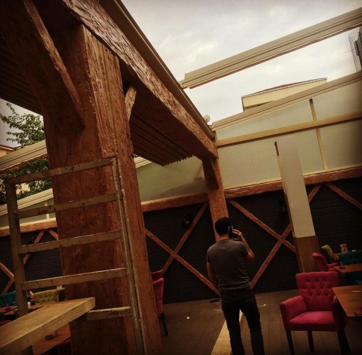 Rustic Workplace Decor with Polyurethane Wood and Iron Details <h2>Rustic Workplace Design with Polyurethane Wood and Iron</h2><p>The rustic workplace style uses polyurethane surfaces molded with natural wood grain patterns, delivering a lasting yet warm atmosphere. Columns and beams are textured to replicate the authentic feel of heavy timber, ensuring a sense of strength. The material also brings resistance against moisture, which is especially valuable in high-traffic environments.</p><p>The wall design features striking diagonal cross motifs that create strong visual geometry reminiscent of traditional carpentry techniques. These crisscross details provide rhythm and highlight the <strong>rustic</strong> character of the space. Combined with iron elements, the design balances raw industrial energy with a handcrafted, welcoming nature.</p><p>Seating adds color contrast, with vivid pink and teal upholstered chairs introducing softness and refinement. Their presence offsets the rugged harshness of wood-like structural elements, ensuring the workplace feels inviting rather than austere.</p><p>Historically, rustic interiors echo the timber framing methods of medieval Europe, where wooden beams were integral not just structurally but symbolically, representing durability. By employing polyurethane imitations of these forms, designers today can replicate that rich visual atmosphere without the weight and maintenance challenges of natural wood.</p><p>This design highlights how the careful blending of <strong>wood texture</strong>, <strong>geometrics</strong>, <strong>durability</strong>, and <strong>artisanal detail</strong> can make a professional workplace feel both efficient and emotionally engaging.</p><ul><li>Polyurethane beams with raw carved-like surfaces</li><li>Wall-cross geometry for balance</li><li>Contrasting upholstered seating for comfort</li></ul>

<p>This rustic workplace interior combines polyurethane beams with carved wood-like textures that deliver both strength and atmosphere. Bold cross patterns on the walls create striking symmetry and visual depth. Bright upholstered chairs add warmth and contrast against the sturdy structures. The material selection ensures lasting <strong>durability</strong> against everyday wear. Combining <strong>wood texture</strong> detailing with raw rustic energy, the design reflects timeless carpentry inspirations. Subtle iron elements contribute to an industrial accent. The contrast of strong and soft features builds a pleasant balance. Crisscross motifs represent classic structural language. This arrangement ensures both endurance and sophistication. The rustic ambience creates comfort for both employees and guests. Traditional forms are reinterpreted with modern technology. This harmony of synthetic and natural expression defines enduring style. Polyurethane allows affordable replication of hand-carved <strong>artisanal detail</strong>. The workplace benefits from structure and aesthetics seamlessly. The overall mood communicates stability, authenticity, and refinement.</p>