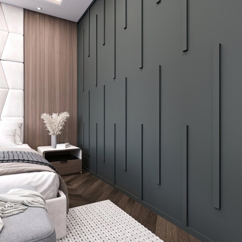 Polyurethane Wall Molding Design for Modern Classic Interiors <h2>Polyurethane Wall Molding in Modern Classic Design</h2><p>The use of <strong>polyurethane molding</strong> in contemporary interiors blends classical detailing with modern abstraction. In this wall application, slim vertical strips are applied against a dark painted surface, creating a clean yet sculptural rhythm that elevates the bedroom’s overall atmosphere.</p><p>The geometric repetition of elongated linear forms avoids clutter while embracing subtle depth. These raised vertical moldings vary in height and spacing, offering a balanced asymmetry that appeals to both modern minimalism and the timeless appeal of detailed <strong>wall panels</strong>.</p><p>Historically, wall moldings have been rooted in the ornamental traditions of European palaces, where plaster and wood were carefully carved to frame spaces. Today, polyurethane provides lightweight durability and flexibility, making intricate shapes more accessible. This adaptation allows the classical concept to evolve into a sleek, modern expression.</p><h2>Color and Material Harmony</h2><p>The dark, muted background establishes a dramatic stage upon which the vertical relief becomes visible without overpowering the room. This bold yet subtle combination works well with light-toned fabrics, wood textures, and monochrome accessories. The effect is both calming and elegant.</p><p>The contrast between the soft upholstered headboard with geometric stitching and the deep textured wall defines zones within the room while maintaining harmony. Together, they create a deliberate dialogue of soft and hard textures, light and shadow play, and contrasting forms.</p><h2>Design Versatility</h2><p>This <strong>interior molding</strong> solution demonstrates its versatility not only in bedrooms but also in living rooms and hallways. The modularity of the linear strips allows designers to experiment with vertical or even diagonal placements. When emphasized with concealed lighting, the relief can gain sculptural prominence, adding a dynamic edge to spaces.</p><ul><li>Verticality subtly enhances ceiling height perception.</li><li>Matte finish reduces glare, ensuring a serene environment.</li><li>Polyurethane material ensures lightweight installation.</li></ul><p>Overall, this <strong>wall design</strong> serves as an elegant compromise between traditional richness and contemporary purity, making it an excellent choice for modern classic interiors.</p>

<p>This polyurethane wall molding design offers a striking solution for modern interiors. The wall features slim vertical strips arranged in a rhythmic sequence. Their geometric variation creates depth without overwhelming the space. The matte surface enhances the clean visual effect. Combined with soft furnishings, the design balances warmth and structure. Its linear motif gently elongates the perception of height. Historically, wall moldings added ornament in palaces, but now they shape sleek spaces. Polyurethane allows precision and durability for this function. The design integrates easily with both wood and fabric elements. It creates an interplay of shadow and relief across the surface. This makes it versatile for bedrooms and lounges. Subtle contrast ensures sophistication in modern classic aesthetics. The geometric detailing softens stark walls while maintaining clarity. Light can be used to emphasize these linear forms. This <strong>wall design</strong> bridges tradition and contemporary minimalism.</p>
