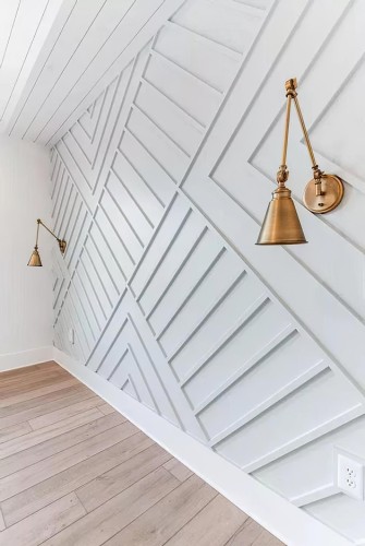 Modern Classic Living Room with Geometric Polyurethane Wall Panels <h2>Geometric Polyurethane Elegance</h2><p>The wall is defined by sculpted <strong>polyurethane</strong> panels forming angled, rhythmic patterns that give depth and character to the space. This use of relief design creates shadows and highlights as the light moves, transforming the wall into a focal point of visual interest. The geometric composition offers a contemporary approach to classical paneling, where tradition meets innovation.</p><p>The metallic <strong>brass</strong> sconces mounted on the patterned wall enhance the balance between classic and modern aesthetics. Their golden tones provide warmth, which contrasts elegantly with the cool, white structure of the wall panels. This balance aligns with the principles of <strong>modern classic</strong> interiors—restrained luxury combined with functional simplicity.</p><h2>Textural and Historical Depth</h2><p>The seamless integration of angular motifs recalls a lineage of <strong>architectural design</strong> traditions. While classical interiors traditionally focused on symmetry and ornamentation, the use of bold diagonal patterns reflects a more modernist interpretation. These intersecting lines echo the timeless fascination with geometry in interior design history.</p><p>The floor, rendered in light-toned wood planks, introduces a subtle material contrast under the bold wall. This organic element softens the sharp edges of the polyurethane patterns and adds an inviting sense of warmth. Together, the facets bring forward an interior that expresses movement yet remains quiet and calm, encouraging personal reflection within its structured design.</p><ul><li>Textured polyurethane panels with angular motifs</li><li>Warm brass lighting fixtures</li><li>Soft wood flooring to balance textures</li><li>Fusion of classical and modern elements</li></ul><p>This interplay of materials and geometry creates a modern classic environment that is both beautiful and personal. It allows the design to serve not only as decoration but as a backdrop for well-being and self-expression.</p>

<p>This interior design emphasizes <strong>polyurethane</strong> wall panels with structured angular patterns. The intersecting motifs create a sense of rhythm and sophistication in the room. Brass sconces mounted on the walls add a refined and timeless glow. Their golden hue balances the crisp white geometry of the wall. The <strong>modern classic</strong> style is emphasized through the fusion of clean lines and luxurious accents. The geometric relief panels create visual depth under changing light. Warm wooden floors soften the sharper architectural accents. The result is a living space that feels both elegant and inviting. This approach draws on centuries of <strong>architectural design</strong> history while remaining fresh. The viewer experiences comfort alongside refinement. Every detail encourages a personal sense of harmony in the space. The brass elements subtly nod to tradition but keep the look current. The angular motifs show how geometry can elevate interiors. Together these choices create an atmosphere of quiet strength and personal expression.</p>