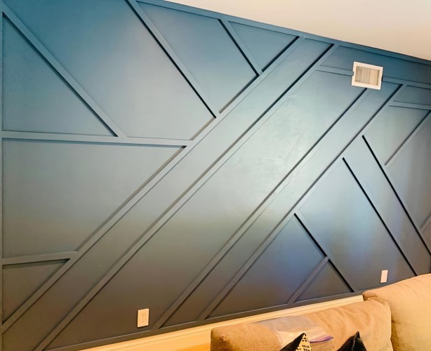 Modern Classic Living Room Accent Wall with Asymmetric Polyurethane Molding <h2>Modern Classic Accent Wall with Polyurethane Details</h2><p>A living room can be transformed dramatically with the use of asymmetric wall molding. In this design, <strong>polyurethane</strong> trim pieces are arranged in diagonal and triangular patterns that create a bold, structured look. The wall is painted in a deep matte tone, which enhances the interplay of shadows and gives the room a sense of elegance and depth. The combination of <strong>geometric</strong> lines and asymmetric balance creates a stylish effect that blends modern simplicity with classic decorative language.</p><p>Polyurethane is a strong, lightweight, and <strong>paintable</strong> material that allows homeowners to customize their walls without the challenges of traditional plaster. Its durability ensures long-term stability, while its smooth finish makes it suitable for various paint applications, from matte to satin and even glossy finishes. With its crisp edges and refined texture, the wall molding enhances the sophistication of the entire interior.</p><p>Historically, wall paneling and molding date back to classical Greek and Roman interiors, where symmetry was the norm. However, the modern twist of using <strong>asymmetric</strong> geometry introduces vibrancy and breaks away from rigid uniformity. This balance of history and innovation brings a unique charm to contemporary living rooms.</p><p>The arrangement of diagonal intersecting pieces introduces visual movement, almost like the flow of dynamic architectural drawings. By strategically creating triangular sections and angled rectangles, the eye is guided across the entire wall surface—a design approach that makes even small living spaces feel larger and more expressive.</p><ul><li>Uses durable and paintable polyurethane material</li><li>Features intersecting diagonal and triangular designs</li><li>Balances modern minimalism with classical decorative references</li><li>Enhances spatial depth through geometric divisions</li></ul>

<p>This accent wall design uses <strong>polyurethane</strong> molding to create a bold visual impact. The intersecting <strong>geometric</strong> lines form diagonals and triangles that add rhythm. The dark matte paint highlights shadows and structure. Asymmetry makes the wall modern yet timeless. Polyurethane ensures durability and paintability. Diagonal divisions produce visual movement. The clean edges give a precise architectural appeal. Classic inspirations combine with a modern twist. The asymmetrical structure softens rigidity. Triangular motifs add variety and depth. This design works well in living rooms seeking personality. Minimalism is balanced with decorative refinement. The wall becomes a central focal point in the room. Both elegance and simplicity are highlighted. The composition transforms flat surfaces into dynamic art.</p>